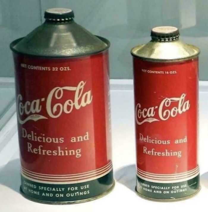 Vintage Coca-Cola cans with old-school design and text