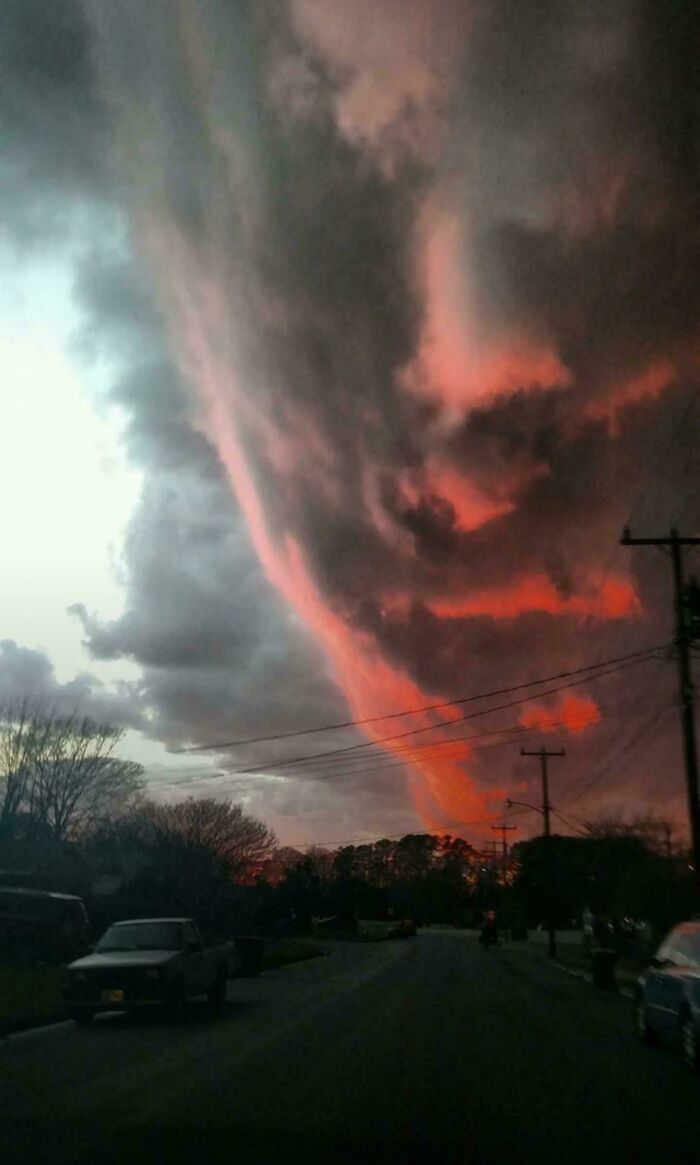 Dramatic ominous red and black storm clouds over suburban street