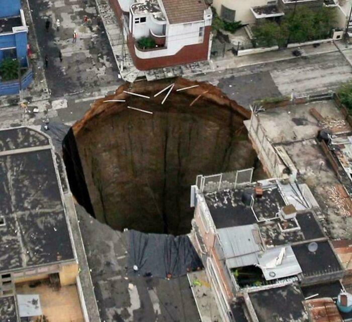 Giant sinkhole swallowed part of city street surrounded by buildings