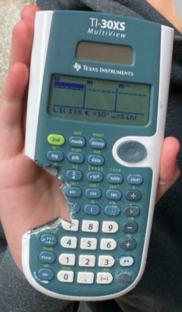 Hand holding a damaged TI-30XS calculator with keys broken off, related to tech support workers' frustrations.