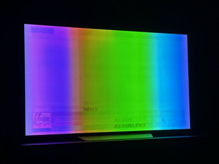 TV screen displaying distorted multicolor vertical bands, illustrating tech support workers wishing they chose a different profession.