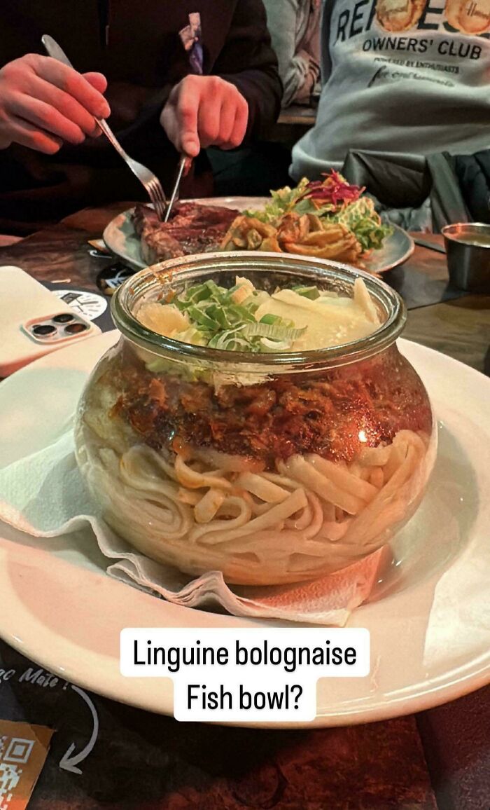 Linguine bolognese served in a fish bowl, showcasing one of the most ridiculous food serving ideas in restaurants.