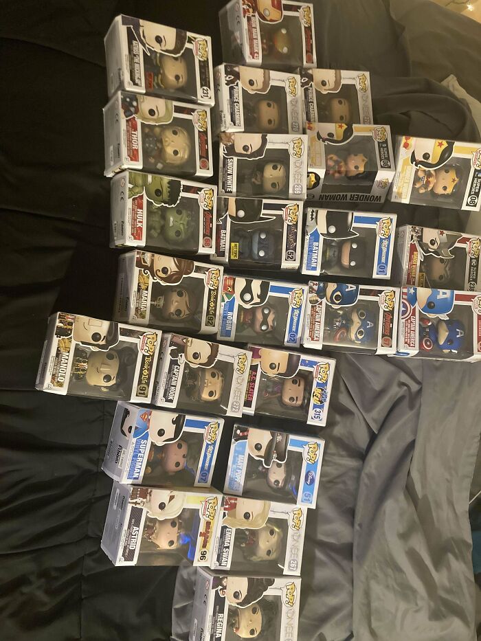 Collection of Funko Pop figures displayed on a bed, showcasing popular characters as dumpster diving treasures.