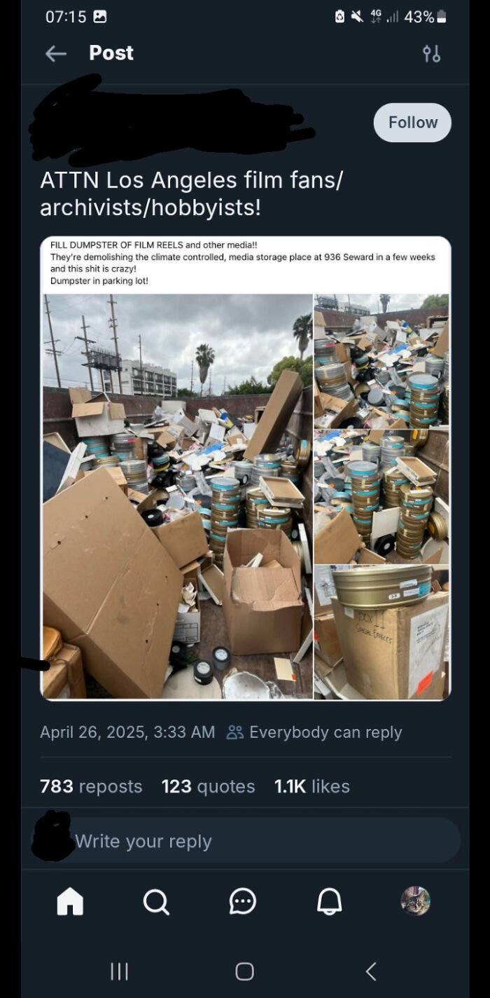 Pile of old film reels and cardboard boxes in a dumpster, showcasing potential dumpster diving treasures.