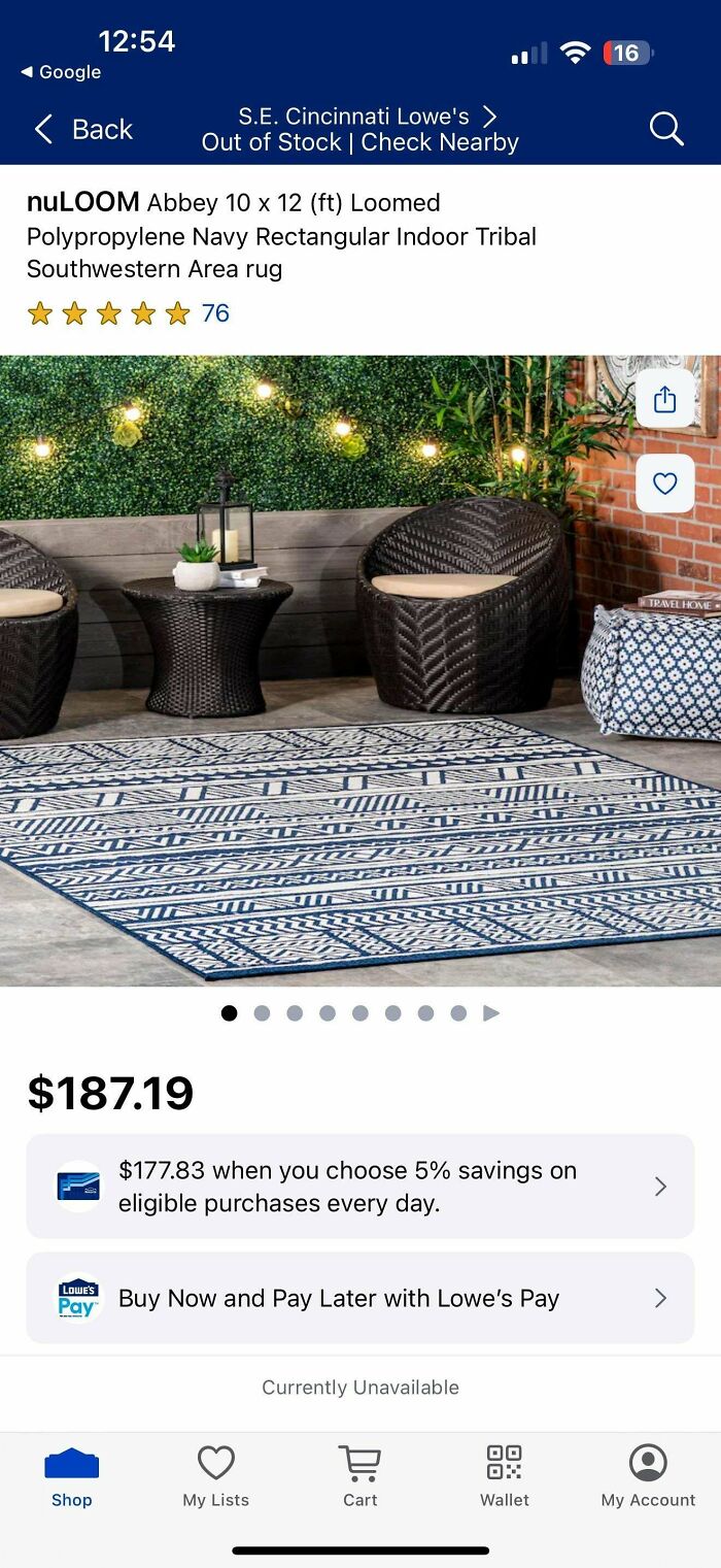 Navy rectangular indoor area rug with Southwestern tribal pattern displayed with outdoor wicker furniture.