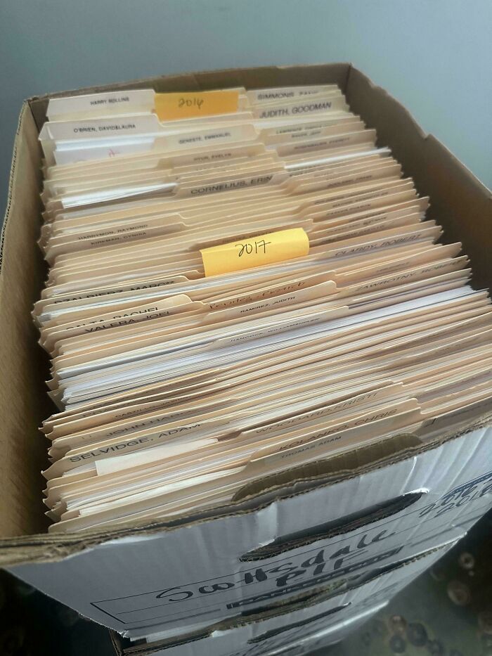 Box filled with organized file folders, a potential dumpster diving treasure your neighborhood raccoons would be wowed by.