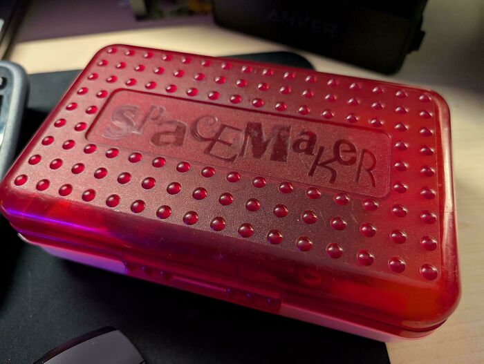 A red plastic pencil case with a textured top and Spacemaker embossed logo, a Buy It For Life purchase.