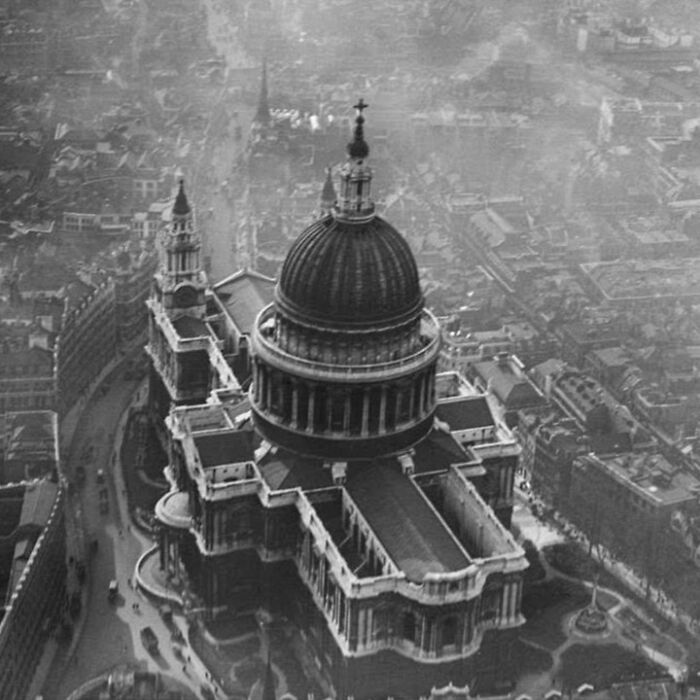 Aerial view of old architecture featuring a historic domed building surrounded by vintage city streets and structures.