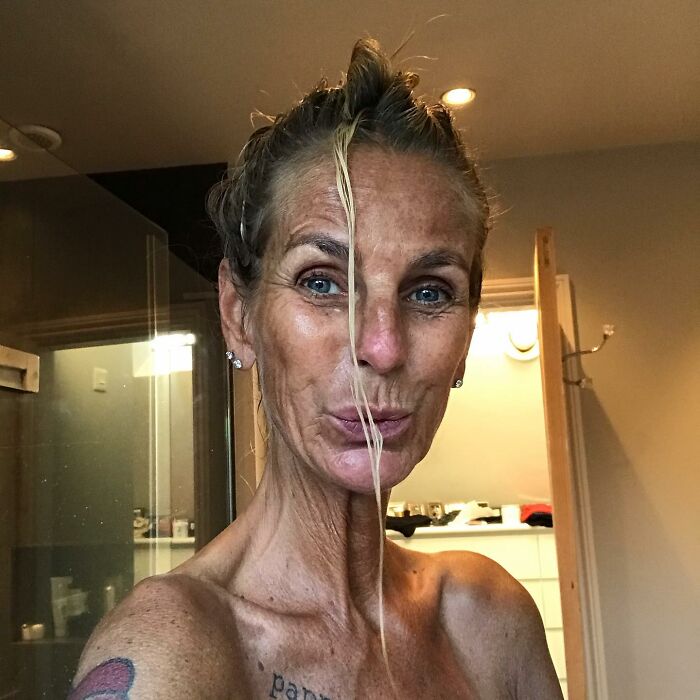 Ulrika Jonsson with over-tanned face and wet hair, addressing trolls in an emotional social media post indoors.