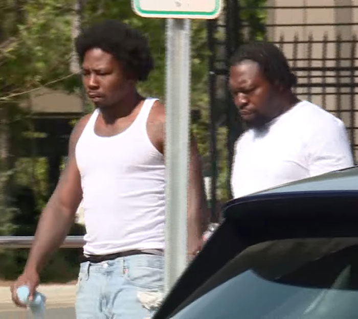 Two men walking near a car, related to a 3-year-old boy in temporary foster care who passed away in a hot car. - 6