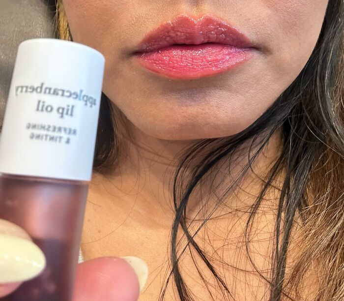 Close-up of lips with shiny lip oil applied, featuring one of the most wished for items burning up Amazon this week.
