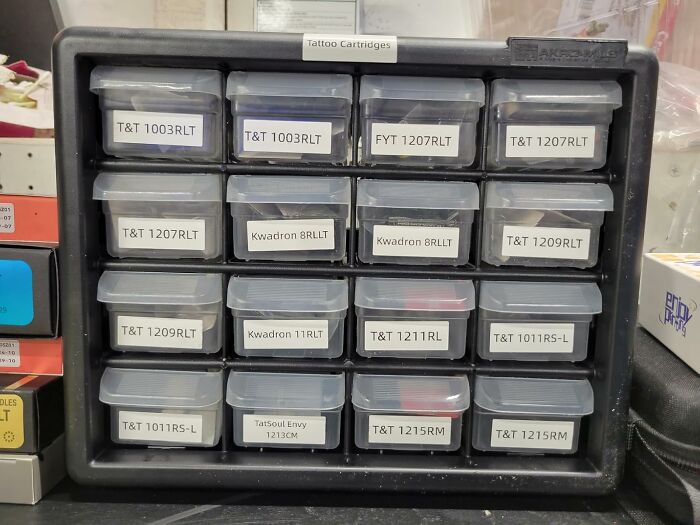 Organized tattoo cartridges in labeled plastic containers, showcasing popular items burning up Amazon this week.