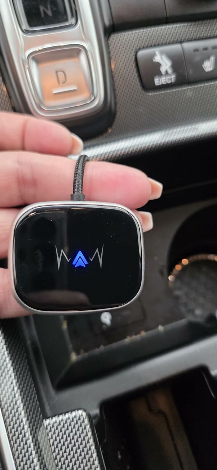 Hand holding a compact electronic device with a digital display, featured in Prime Day electronic deals shopping guide.