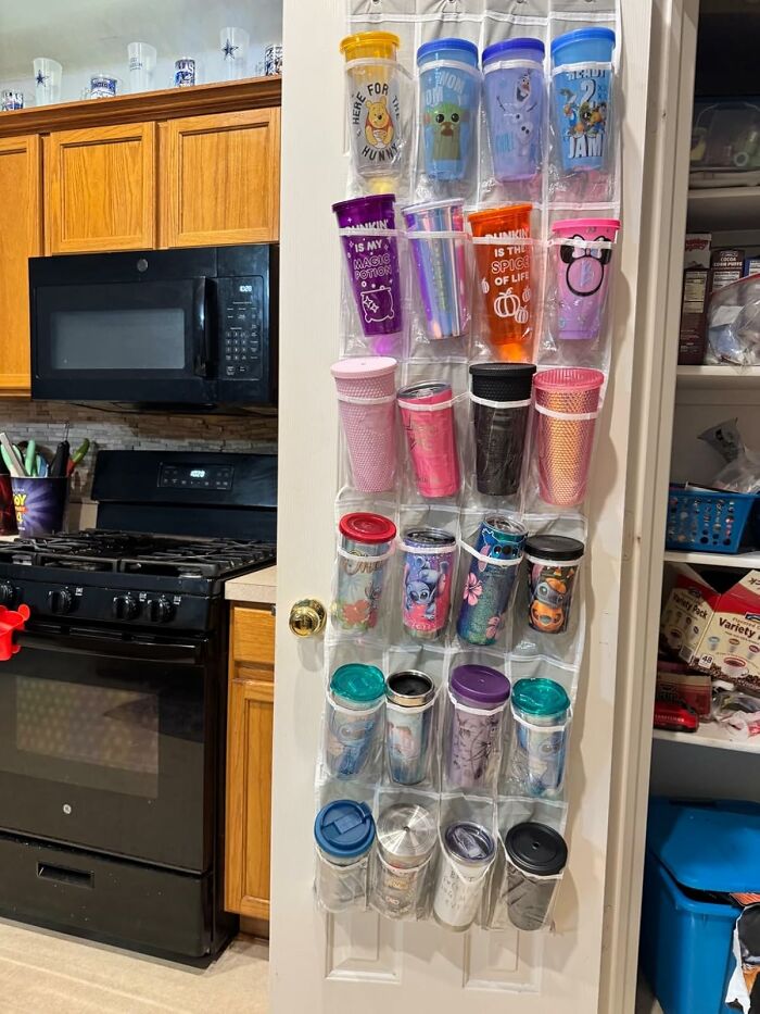 Kitchen storage hack showing a door organizer holding multiple reusable tumblers for clever home hacks.