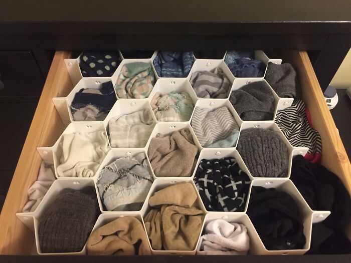 Organized drawer with hexagonal compartments to hide and store clutter, a smart way to hide ugly eyesores in your home.