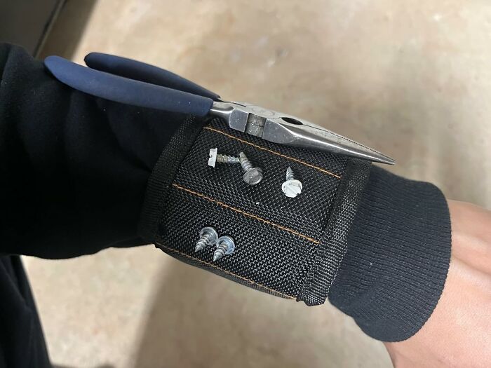 Magnetic wristband holding screws and nails, showcasing a random useful tool for handy tasks and repairs.