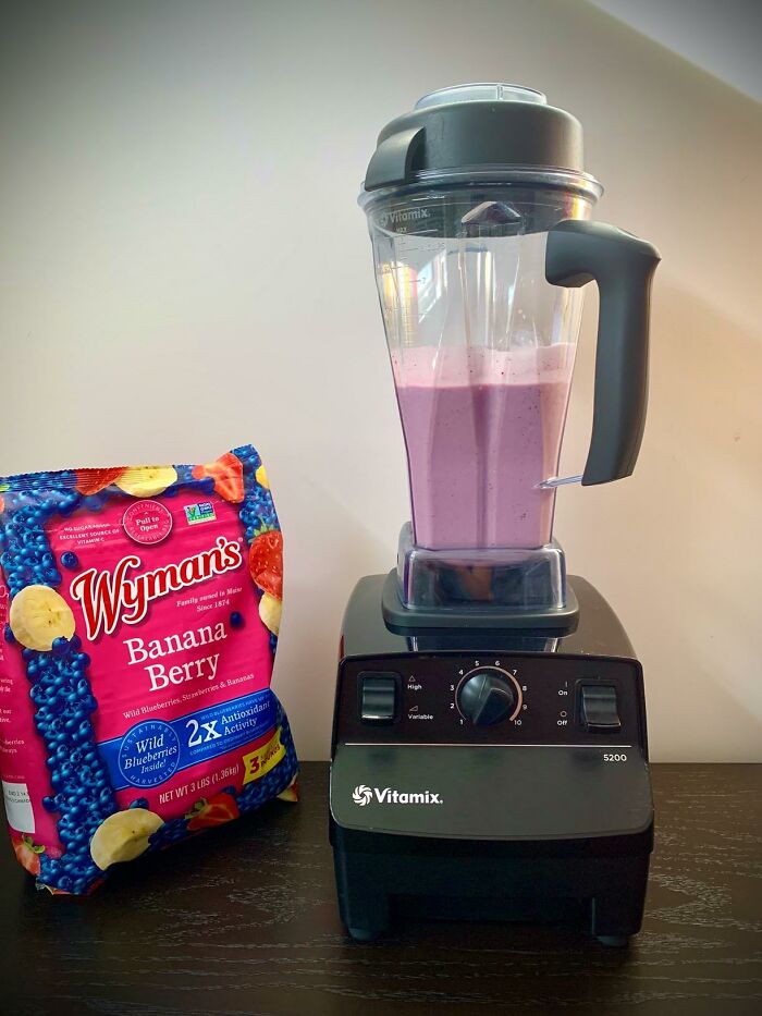Vitamix blender with a pink smoothie next to a bag of Wyman’s Banana Berry fruit blend, highlighting Prime Day deals.