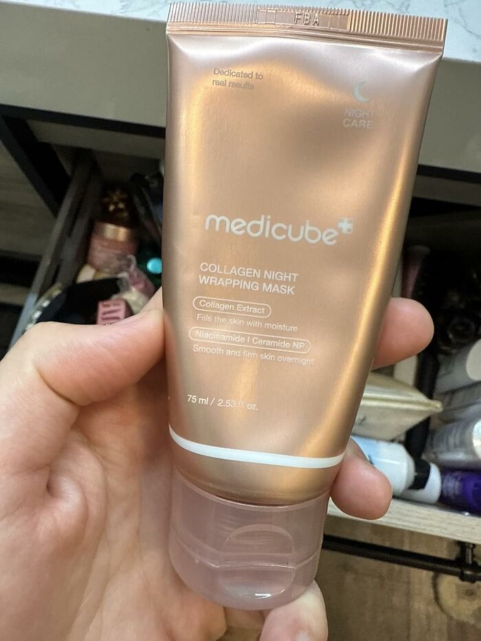Hand holding a Medicube collagen night wrapping mask, one of the best sellers that topped the charts on Prime Day.