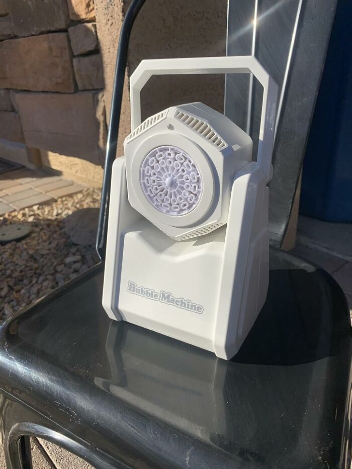 White bubble machine sitting on a black chair outdoors, one of the weirdest picks found on Amazon.