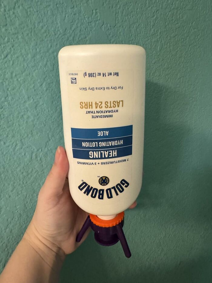 Hand holding Gold Bond Healing Hydrating Lotion with aloe, one of the favorite problem solvers under $15.