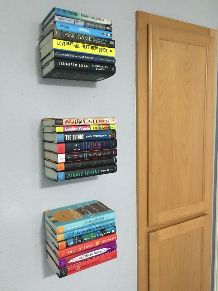 Stacked books appear to float on a wall using clever products to organize chaotic corners of a home.