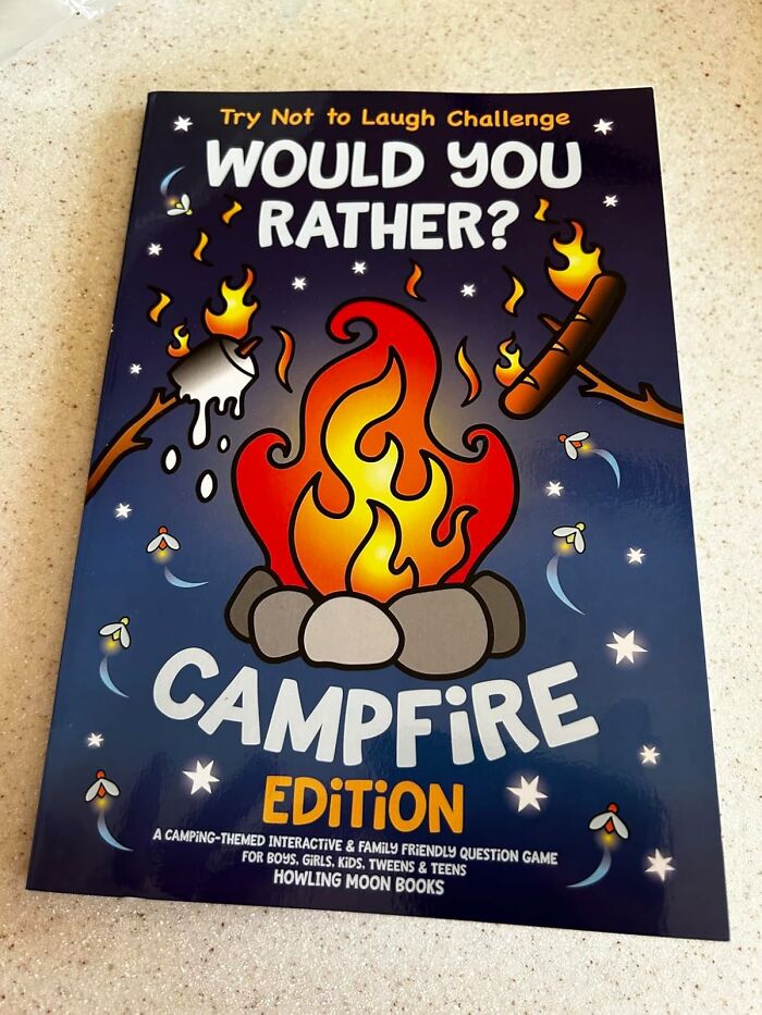 Would You Rather Campfire Edition book cover with campfire, marshmallow, and hotdog roasting sticks for camping hacks.