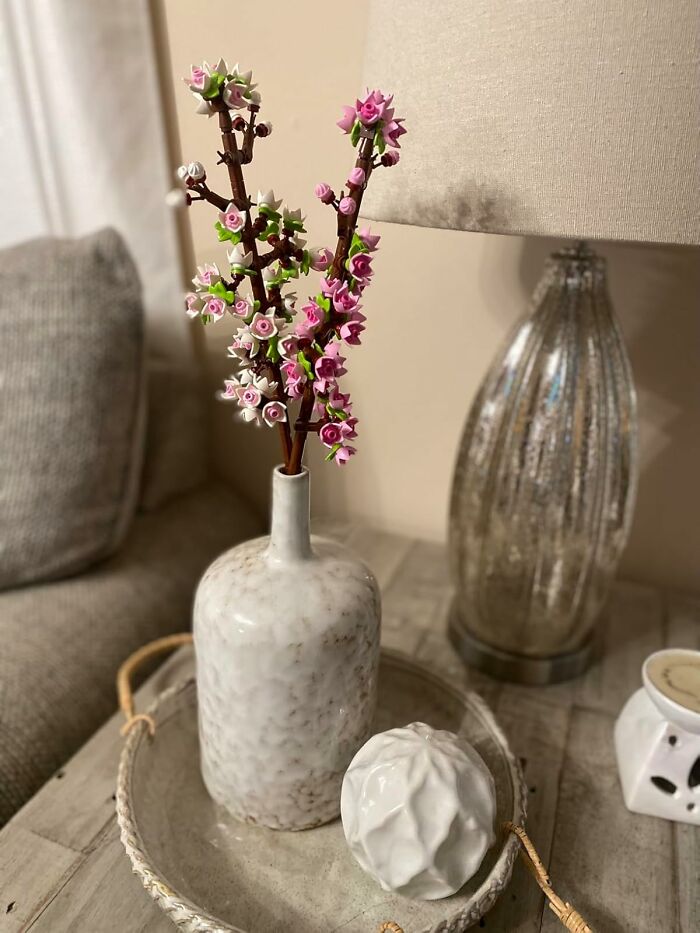 Decorative ceramic vase with pink and white artificial flowers creating a dopamine hit with unique novelty finds.