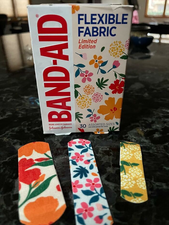 Box of limited edition flexible fabric BAND-AID bandages with colorful floral patterns, novelty finds for a dopamine hit.
