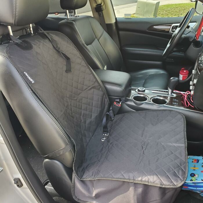 Passenger seat car accessory organizer cover protecting leather seat and providing storage in a vehicle interior.