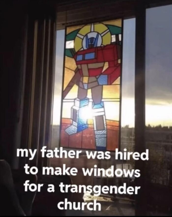 Stained glass window featuring a robot design with weird and unhinged humor meme text about a transgender church.