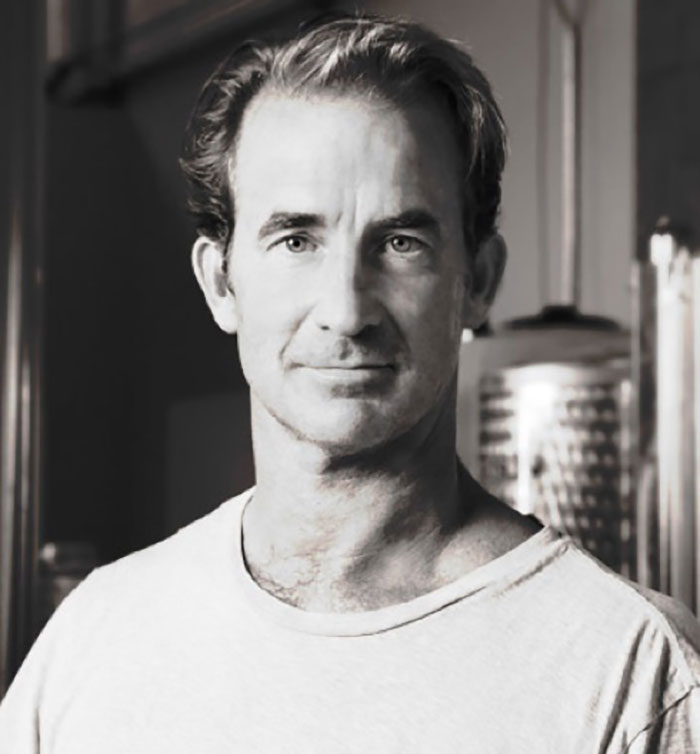 Black and white portrait of a man indoors, related to Coldplay HR exec mortgage news story. - 9