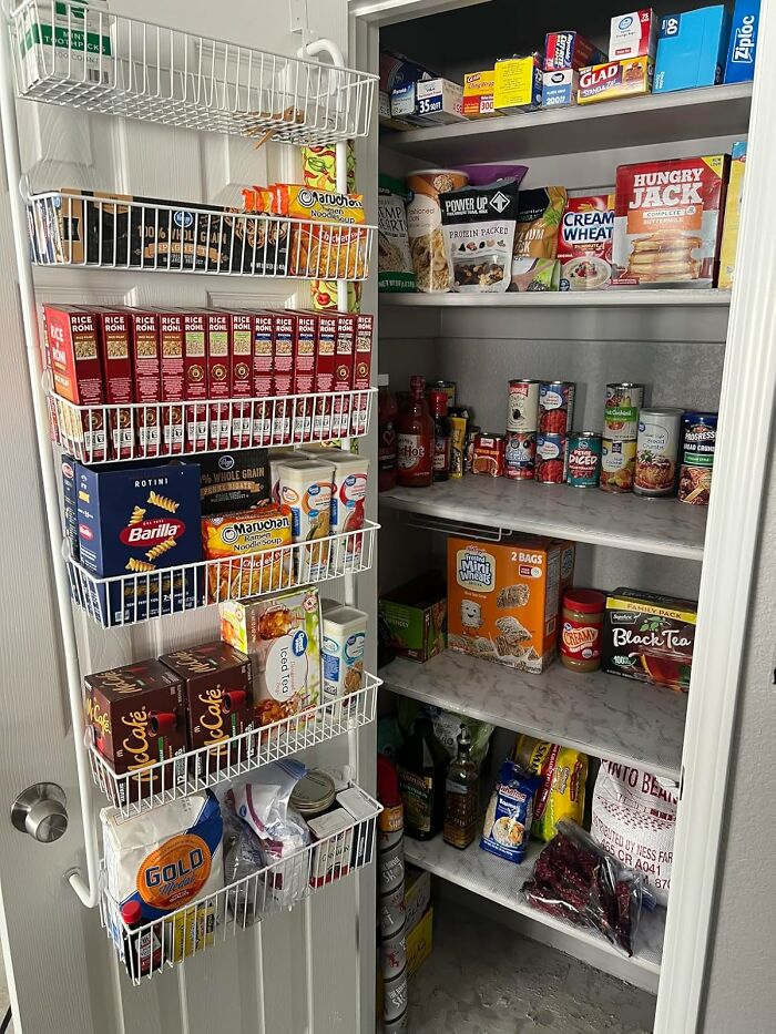 Organized pantry with wire racks and shelves neatly storing snacks, cans, and food items for chaotic corner home organization.