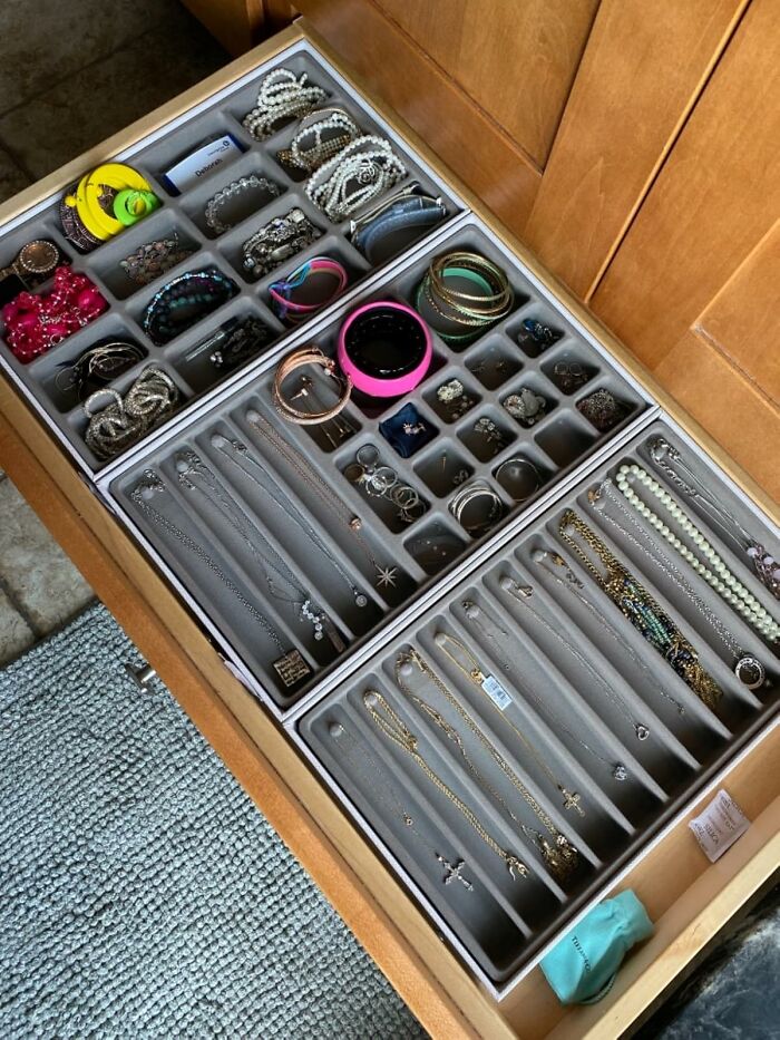 Jewelry drawer with organized compartments showcasing bracelets, necklaces, rings, and earrings for clever home organization.