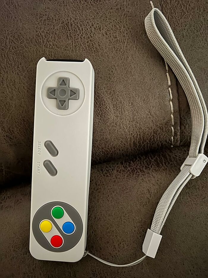 Retro gaming controller with colorful buttons and wrist strap, a nostalgic find for old soul collectors and enthusiasts.