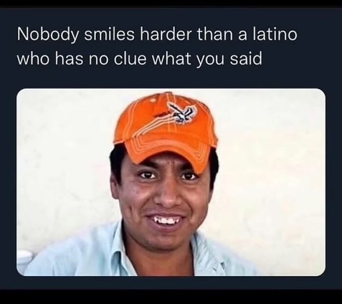 Man wearing orange cap smiling awkwardly, illustrating funny meme about Hispanic experience and language confusion.