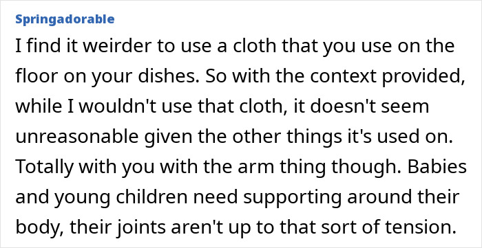 Husband carries infant by the arms and wipes face with dishrags, wife concerned about baby&rsquo;s safety and hygiene.