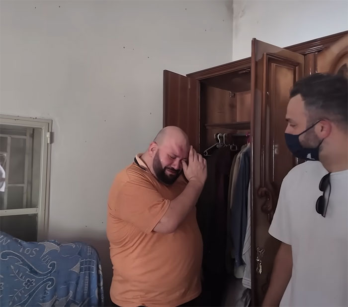 Man in orange shirt emotionally reacts while visiting family home 46 years after dad left, showing stunned discovery. - 7