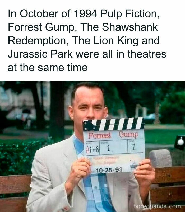 Man holding a Forrest Gump clapperboard from a nostalgic post capturing the magic of growing up in the ’90s.