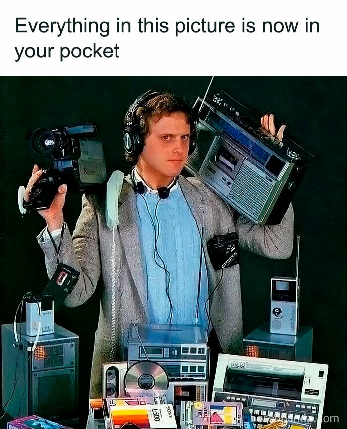 Man surrounded by nostalgic ’90s gadgets like a camcorder, boombox, cassette player, and early digital devices, showing growing up magic.