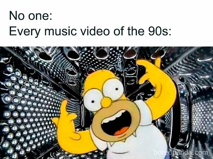 Homer Simpson making hand gestures in a metallic tunnel, representing nostalgic 90s music video vibes.