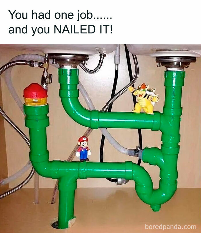 Plastic green pipes under a sink with Mario and Bowser toys, capturing nostalgic posts about growing up in the ’90s.