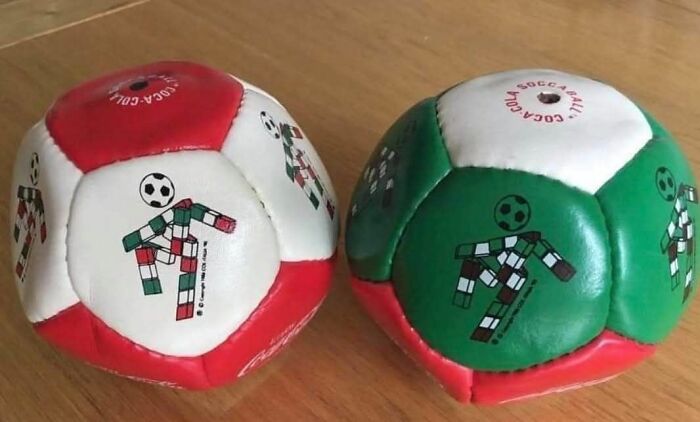 Pair of vintage soccer balls with classic designs, evoking nostalgia for growing up in the ’90s era.