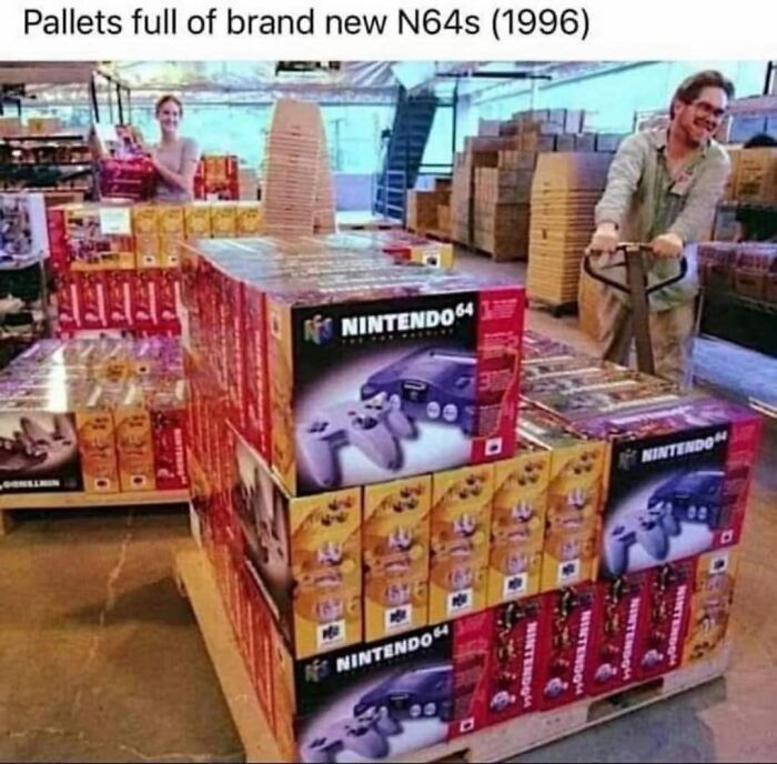 Pallets stacked with brand new Nintendo 64 consoles in a warehouse, capturing 90s nostalgia and childhood gaming memories.