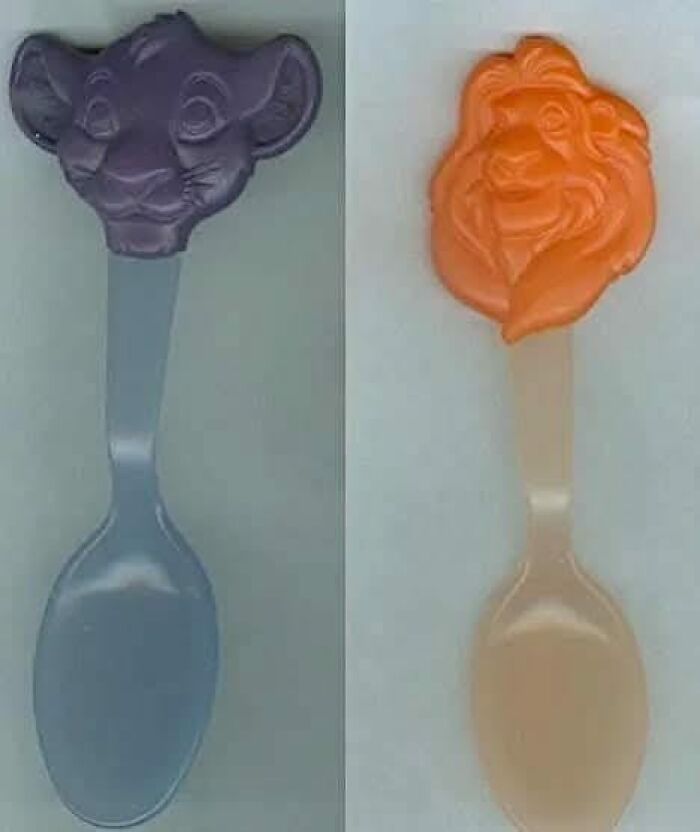 Two vintage plastic spoons with Lion King character tops, evoking nostalgic posts about growing up in the ’90s.