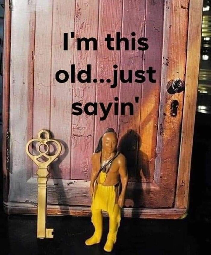 Vintage action figure with a large ornate key in front of a wooden door, evoking nostalgic posts about growing up in the ’90s.