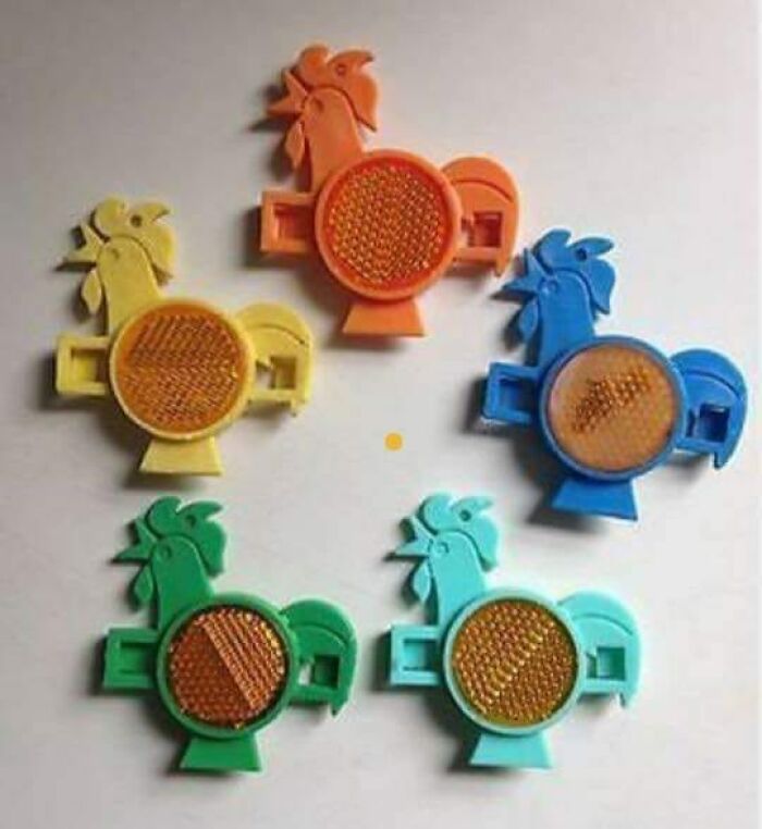 Colorful vintage rooster-shaped reflectors from the ’90s, evoking nostalgic memories of growing up in that decade.