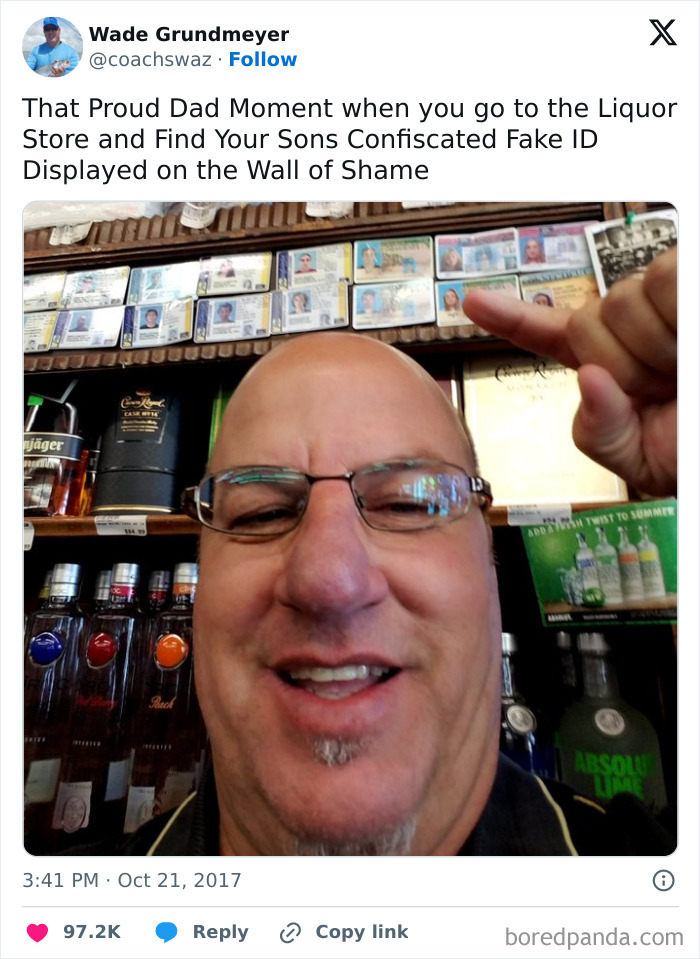 Hilarious dad proudly points at confiscated fake IDs displayed on a liquor store wall, nailing fatherhood humor.