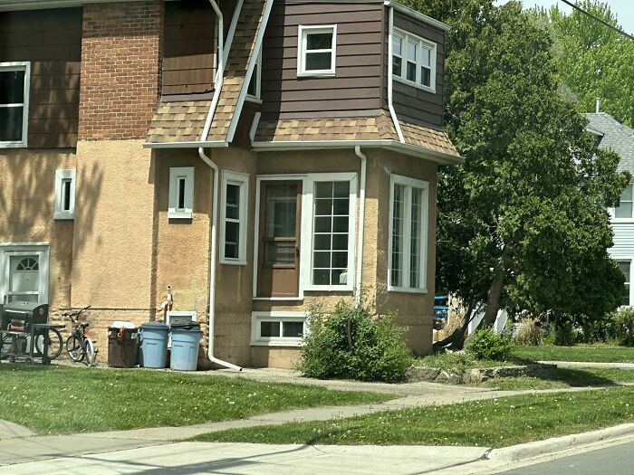 House with mismatched windows and doors showing a failed creative home design attempt in a residential neighborhood.