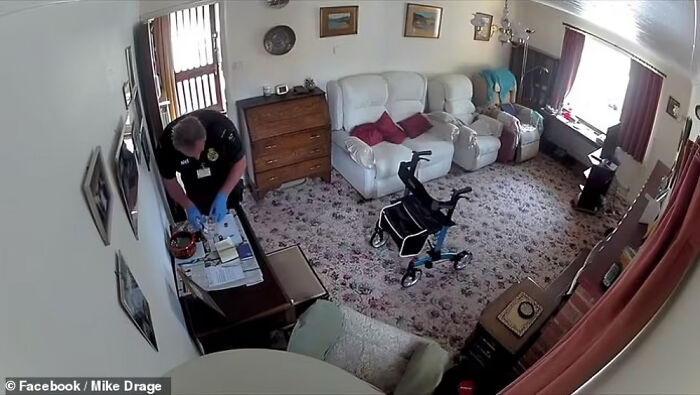 Security guard in a living room bending over a desk, illustrating consequences of stupidity leading to job loss.