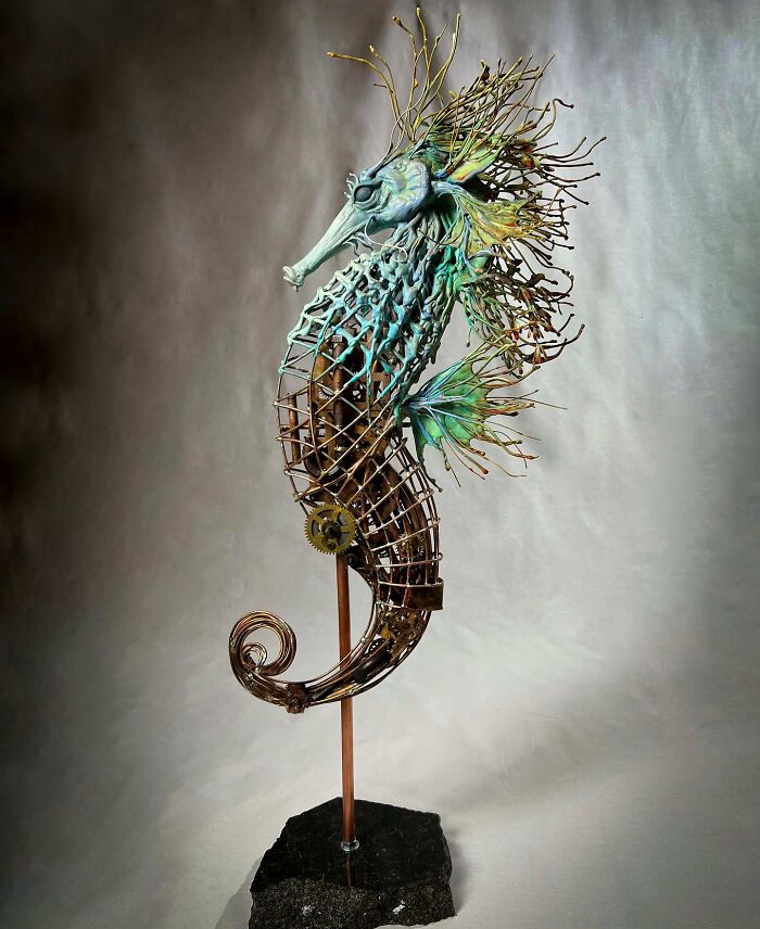 Seahorse sculpture made from scrap metal showcasing striking animal art with intricate details and vibrant colors.